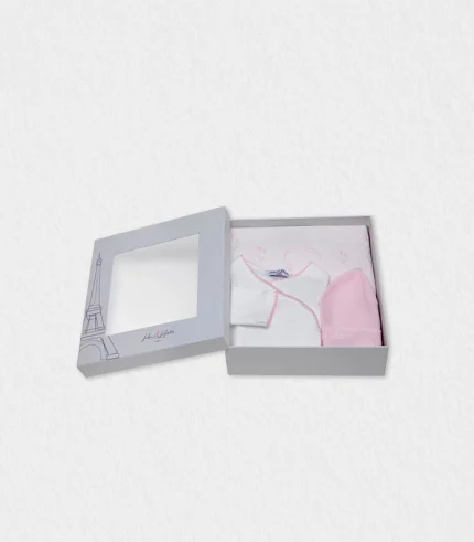 Front‑view of the organic cotton baby gift set laid on a cream backdrop in Dubai studio lighting, featuring butterfly‑embroidered pyjama, matching hat and blanket folded beside the keepsake Eiffel‑Tower box ready for global shipping—organic cotton baby gift set ideal newborn present shipped worldwide from Dubai.