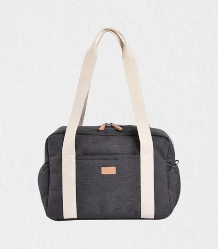 baby changing bag Paris Puffy quilted blue exterior hanging on stroller beside Burj Khalifa, showing roomy 25 L interior, insulated pocket and padded mat—perfect Dubai baby gift shipped worldwide for newborn and toddler travel essentials, unisex style for modern parents.